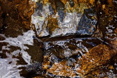 stone under the mountain water, note shallow depth of field