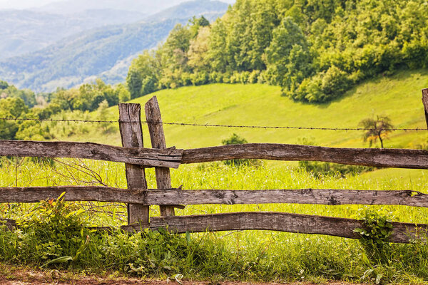 fence from wooden planks on the mountain, note shallow depth of field