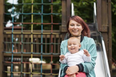 Genç anne mutlu bir yaz parkta genç bir çocuk ile vakit.