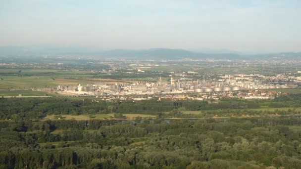 Aerial view Oil refinery or fuel depot next to a river with a major city in background — Stock Video