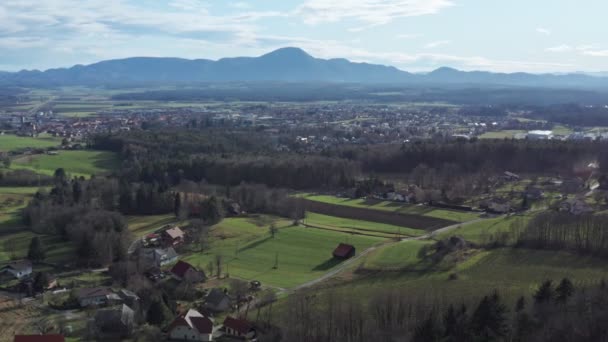 Aerial view of east Slovenian countryside, Slovenska Bistrica in front with Boc and Haloze hills in the background, view from Pohorje, European rural countryside, travel and eco tourism concept — Stock Video