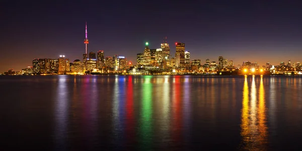 Toronto cityscape panorama at dusk over lake with colorful light — Stock Photo, Image