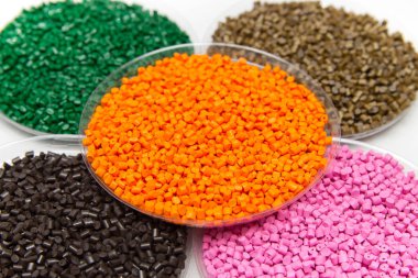 The plastic granules. Dye for polypropylene, polystyrene granule  into a measuring container clipart