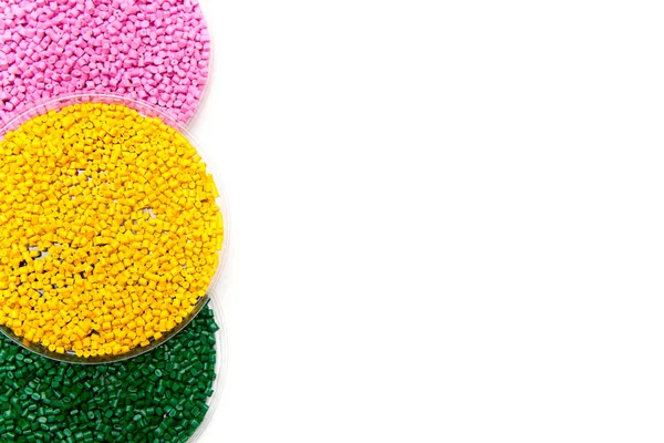 Plastic pellets green yellow and pink . Colorant for polymers in granules. Template — Stock Photo, Image