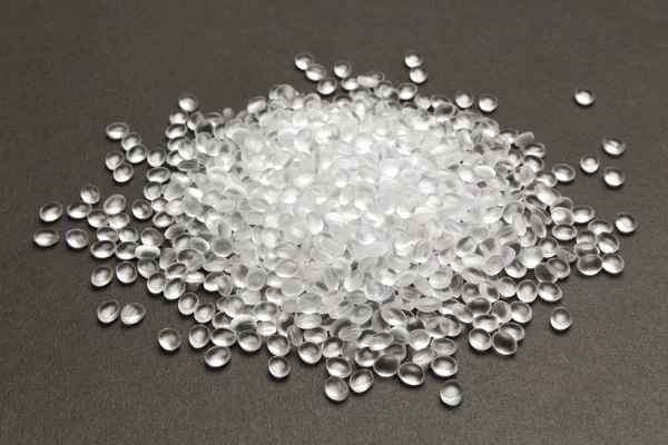 Transparent Polyethylene granules on dark .HDPE Plastic pellets. — Stock Photo, Image