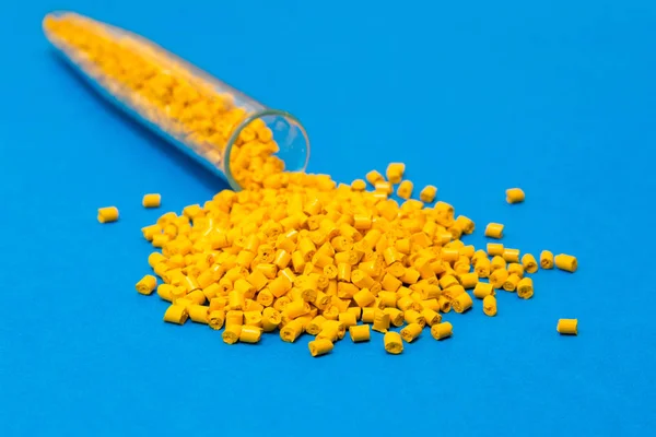 Plastic raw materials in granules for industry.Yellow Polymer on — Stock Photo, Image