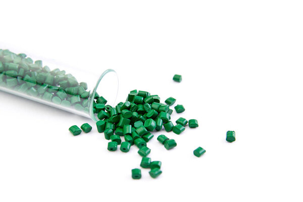 Plastic pallets . Plastic raw materials in granules for industry. Polymeric dye is green on a white background. Plastic granules after processing of waste polyethylene and polypropylene.Polymer.