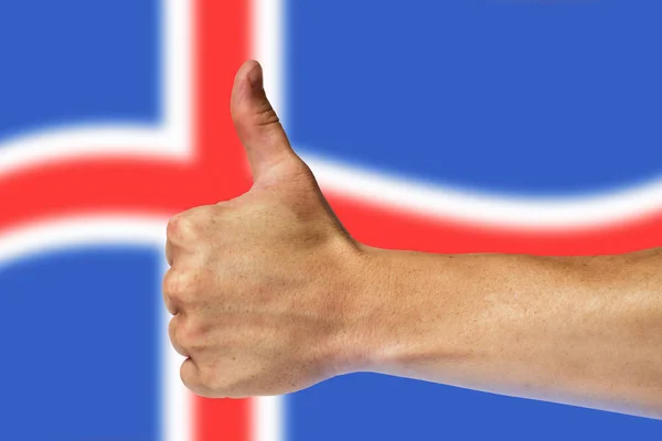 Kciuki do góry na tle flaga Islandii — Zdjęcie stockowe