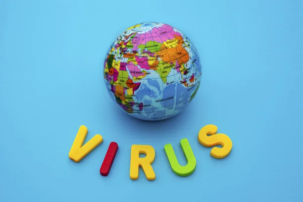 Globe and text VIRUS on a blue background. Coronavirus / Corona virus concept. The spread of corona virus in the World.