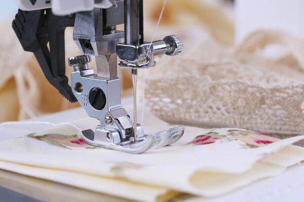 The sewing process, on an electric sewing machine. Household.