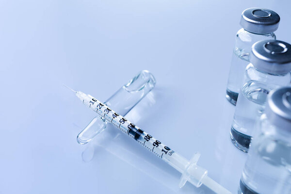 Ampoules, vials, syringe. Medical injection,diseases,health care,diabetes,insulin. Syringe with liquid vaccines preparing to do an injection. Medical equipment. Medical background with copy space