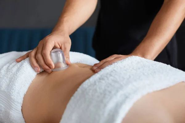 Młoda piękna kobieta korzystających z masażu filiżanek w spa.Professional masażystka leczy pacjentkę w apartamencie.Relaks, piękno, ciało i twarzy leczenie koncept.Home masaż — Zdjęcie stockowe