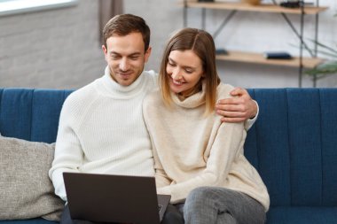 Evde kal. İnternetteki bir toplantı için dizüstü bilgisayar kullanan gülümseyen aile portresi, video görüşmesi, ebeveynlerle, çocuklarla, akrabalarla video konferansı. Kendini soyutlama. Karantina döneminde evde vakit geçirmek