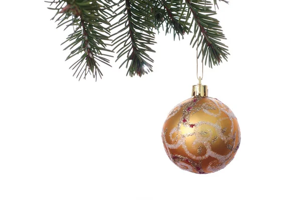 Gold Christmas balls with ornament on the green fir branch. Whit — Stock Photo, Image