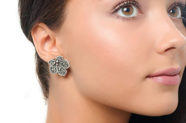 Young beautiful girl wearing stylish earring. Close-up studio po — Stock Photo, Image