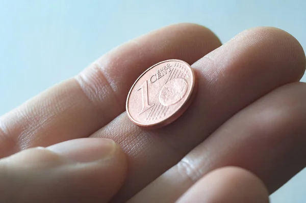 A male thumb and index finger gripping a one Euro cent Coin. — Stock Photo, Image
