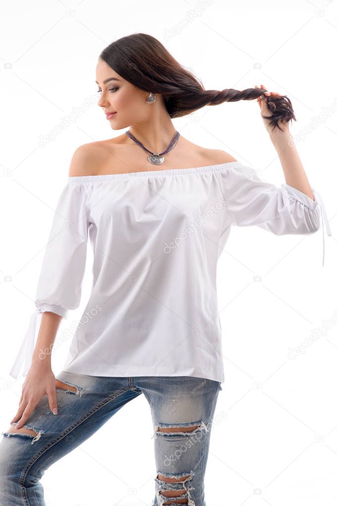 Long brown hair model wearing Ripped Jeans and white mini dress 