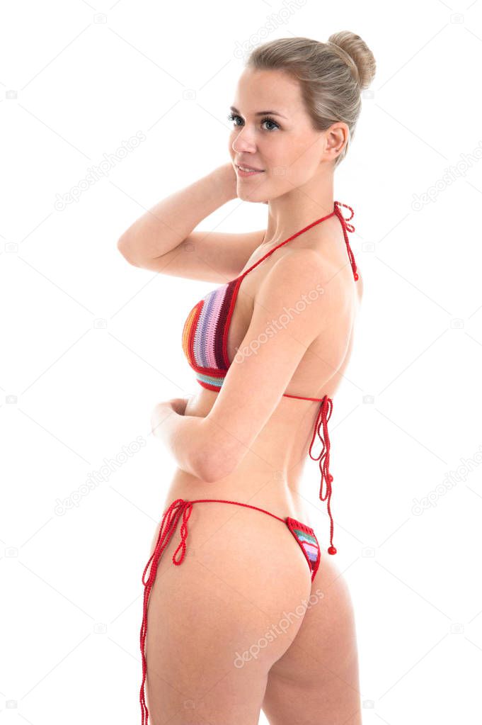 Model wearing knitted swimsuit. Red swimsuit on a sporty beautif