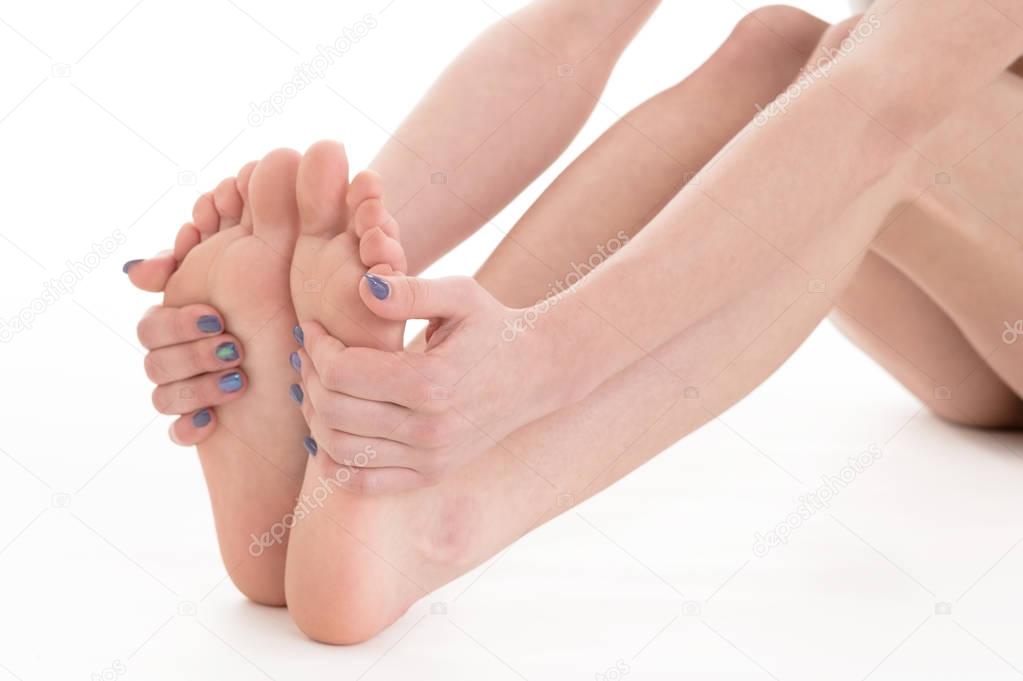 Female feet and hands with manicure on white background