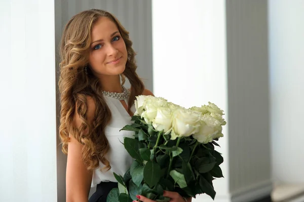 Fiatal gyönyörű nő, Fehér Rózsa virágok csokor pózol — Stock Fotó