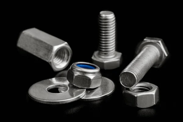 Chrome Bolts and Nuts isolated on black — Stock Photo, Image