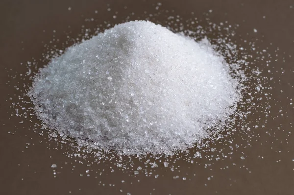 Heap of granulated white sugar on gray background Stock Image
