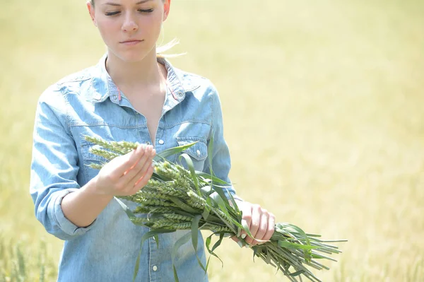 woman agriculture engineer standing in green wheat field with ea