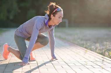 Sprinter kız başlangıç konumu yolda. Koşu spor