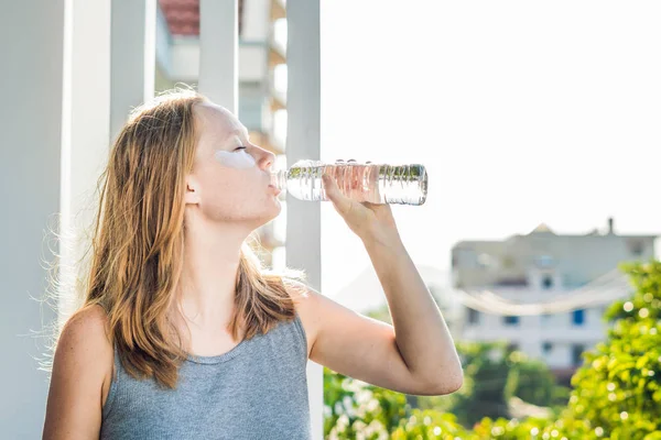 Portrait of Beauty Red-haired woman with eye patches drinks water. Spa Girl — Stock Photo, Image