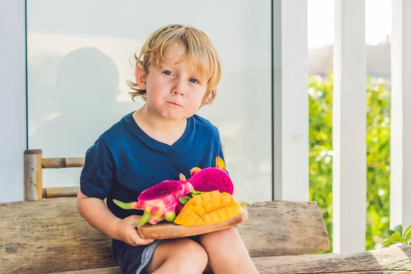 boy with dragon fruit and mango