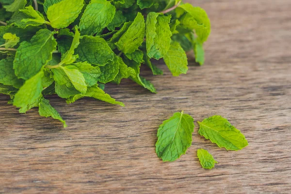 Fresh mint on wooden table — Stock Photo, Image