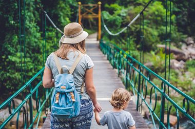 Anne ve oğlu bir asma köprü üzerinde gidiyoruz