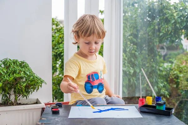 Pequeño niño pintando con pinturas de colores — Foto de Stock