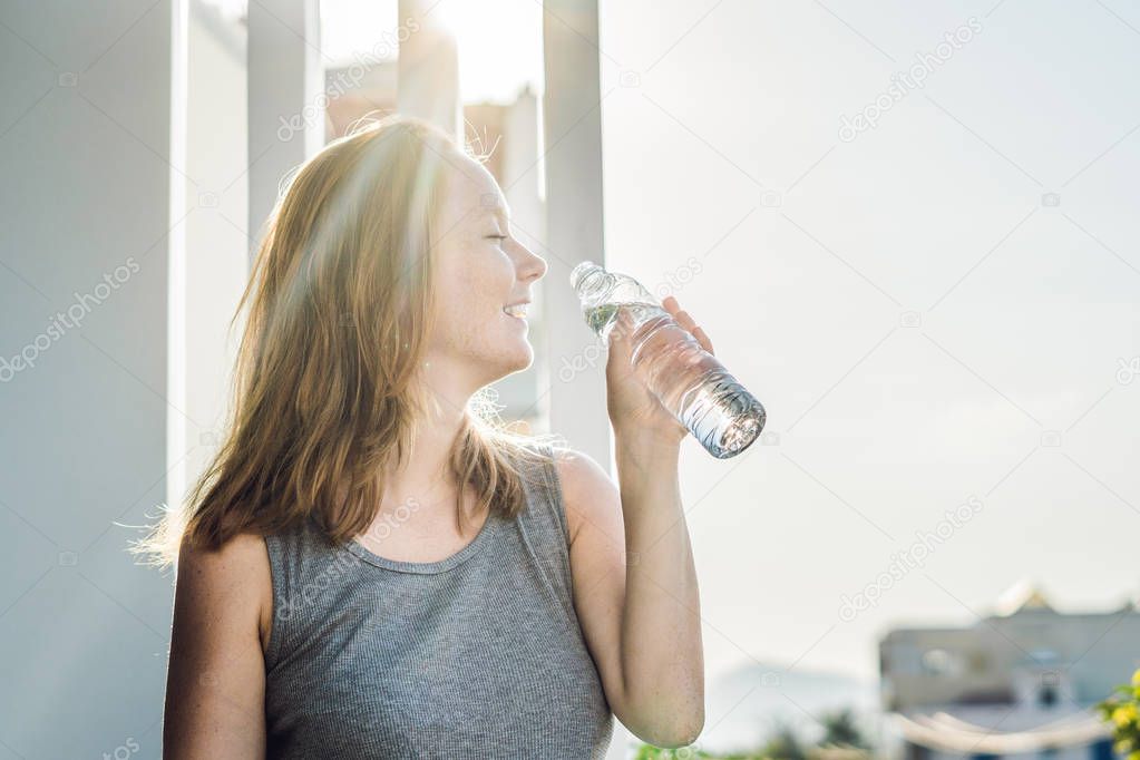 Young woman is drinking water 