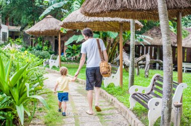 Baba ile oğlu yolda bir parkta yürüyüş