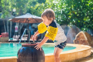  boy washes the feet of the sand  clipart