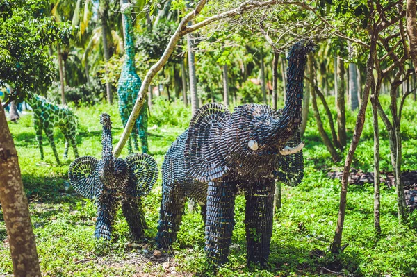 statue of an elephant made from recycled bottles medical. Waste recycling concept