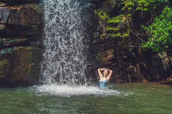 Woman is standing in a waterfall — Stock Photo, Image