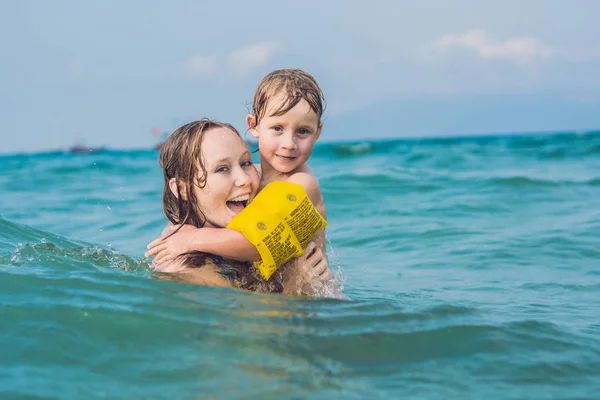 Giovane madre nuotare con ragazzo — Foto Stock