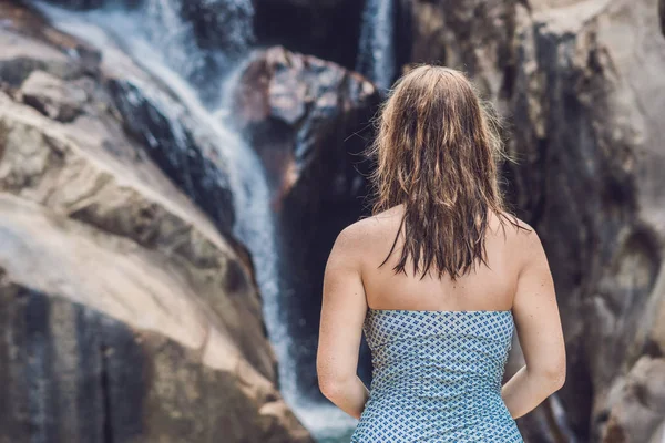 Woman  standing on a waterfall background — Stock Photo, Image