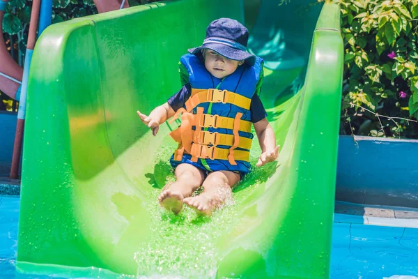 Boy  slides down from a slide — Stock Photo, Image