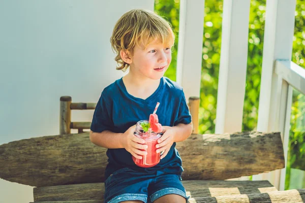 Boy is holding Healthy watermelon smoothie — Stock Photo, Image