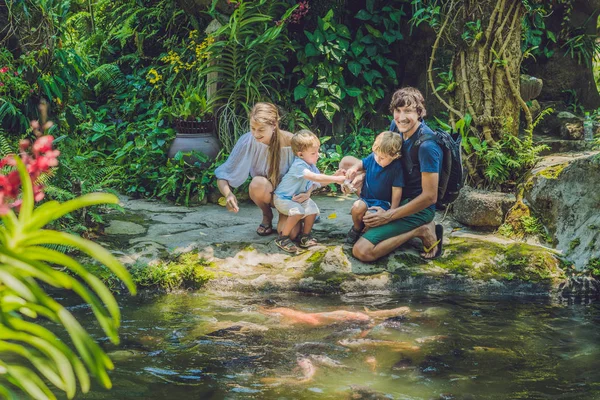 happy family feeding colorful Catfish