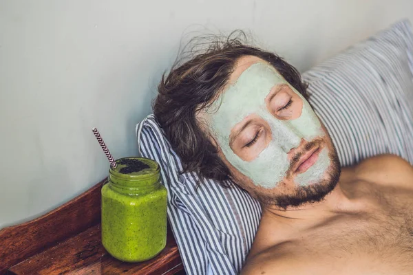 man applying  green clay Mask