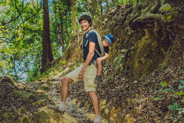 Father carries his son in a baby carrying — Stock Photo, Image