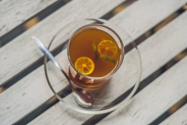 Tangerine tea on a table clipart