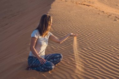 young woman in  desert at sunset clipart