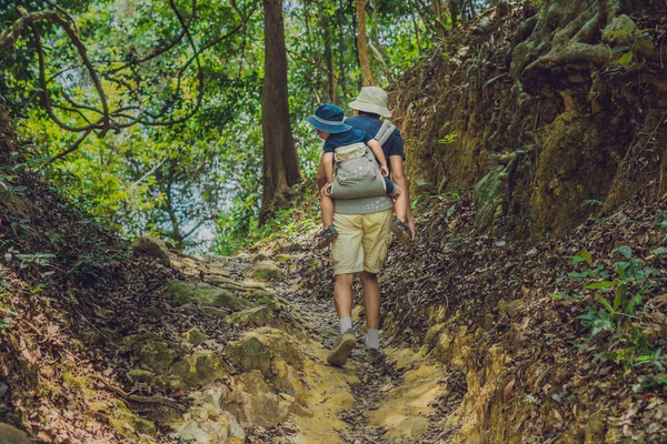 Tourist is carrying a child on his back