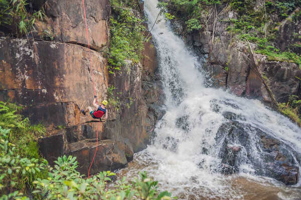 Climber near cascading Datanla waterfall