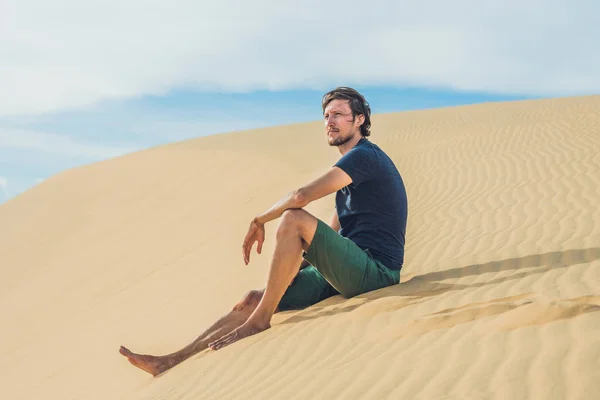 Az ember ül a homokba — Stock Fotó